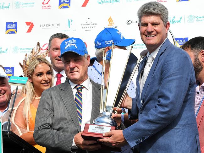 Trainer Gregory Hickman (left) poses for a photograph with Queensland Racing Minister Sterling Hinchcliff after Pierata won race 7, the Magic Millions Three-Years-Old Guineas, during the Gold Coast Magic Millions at Aquis Park, Gold Coast Turf Club, Queensland, Saturday, January 13, 2018. (AAP Image/Albert Perez)