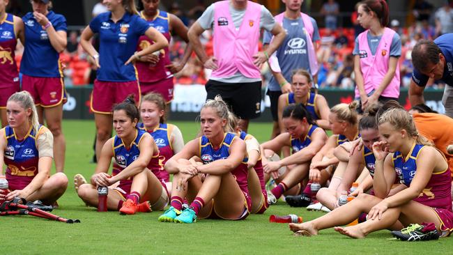 The Lions sit dejected after losing the Women's AFLW Grand Final. Picture: Adam Head