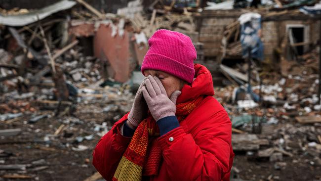 Irina Moprezova, 54, reacts in front of a house that was damaged in an aerial bombing in the city of Irpin, northwest of Kyiv. Picture: AFP