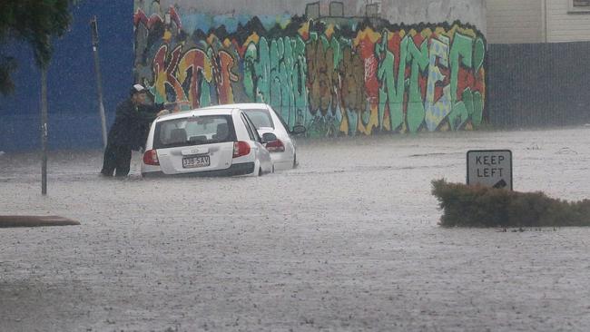 A badly flooded street in East Brisbane — a sight repeated across the city as heavy rain from ex-cyclone Debbie inundates southeast Queensland. Picture: Darren England.