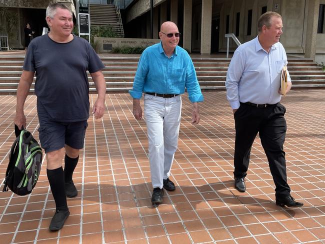 Mark Fishburn, Tony Green, and Alan Sheret  leave the Townsville Courthouse after appearing in the Planning and Environment Court.