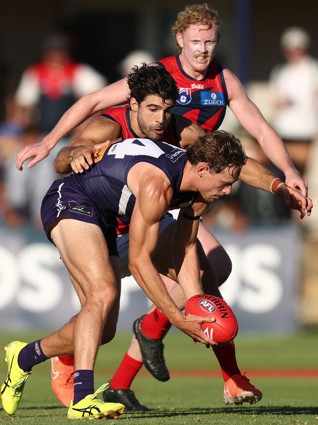 Matthew Johnson facing heavy pressure from Christian Petracca in the AAMI Series. Picture: Paul Kane/Getty Images