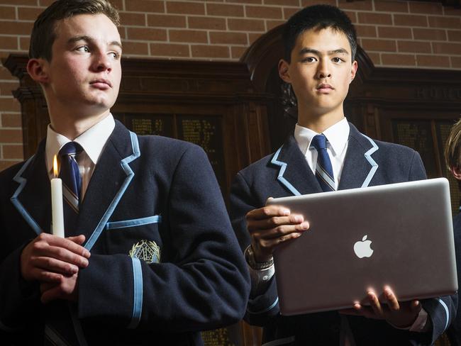 Candles and computers ... Year 11 Camberwell Grammar students Hugh Emmett and Michael Liu will use AnzacLive in their WW1 commemorations. Picture: Eugene Hyland