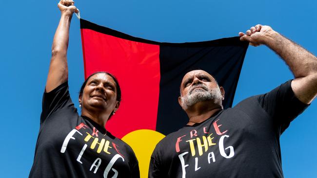 Nova Peris and Michael Long stand with the Aboriginal flag at Gardens Oval, Darwin ahead of the AFL's Dreamtime Round. Picture: Che Chorley