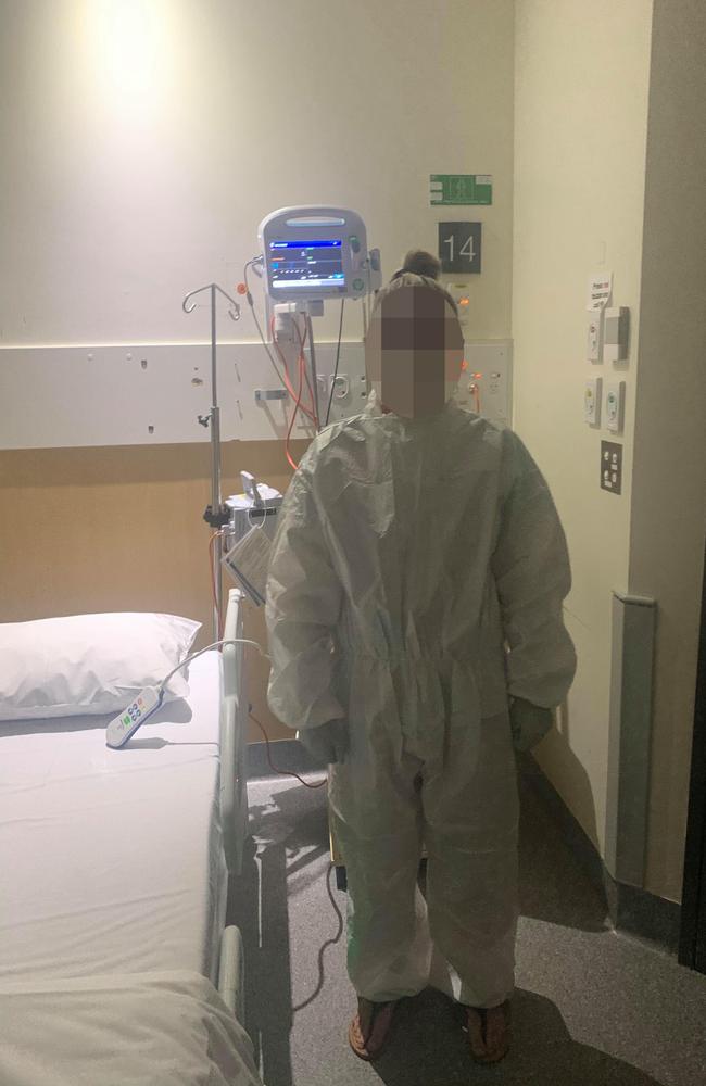 Ipswich resident Cassie, with her face blurred, in her protective suit and face mask after being taken to hospital following her diagnosis of COVID-19. Picture: Supplied