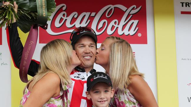 Australian cyclist Robbie McEwen with his son and a pair of podium support staff. Picture: AFP