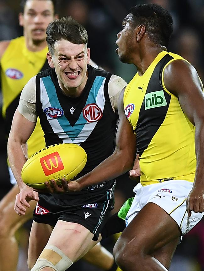 Maurice Rioli looks to handball over Port Adelaide’s Zak Butters. Picture: Mark Brake/Getty Images