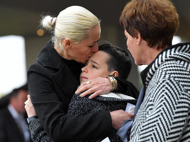 Ms Lekaj’s brother Pyrrhus being comforted by mother Romina and grandmother at her funeral. Picture: Tom Huntley