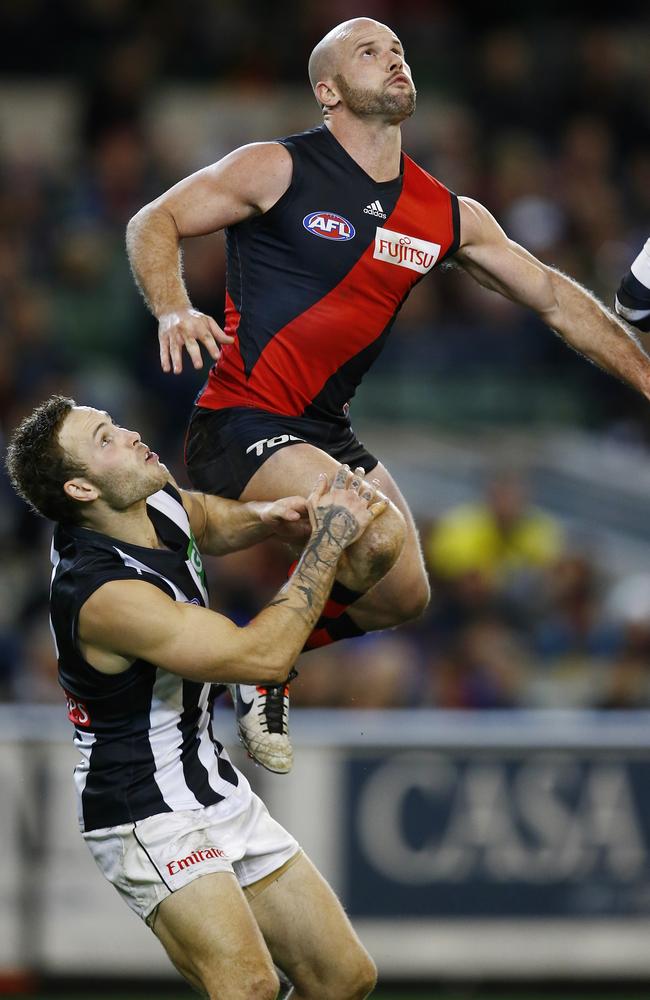 Bomber Paul Chapman flies high over Magpies tagger Brent Macaffer. Picture: Michael Klein