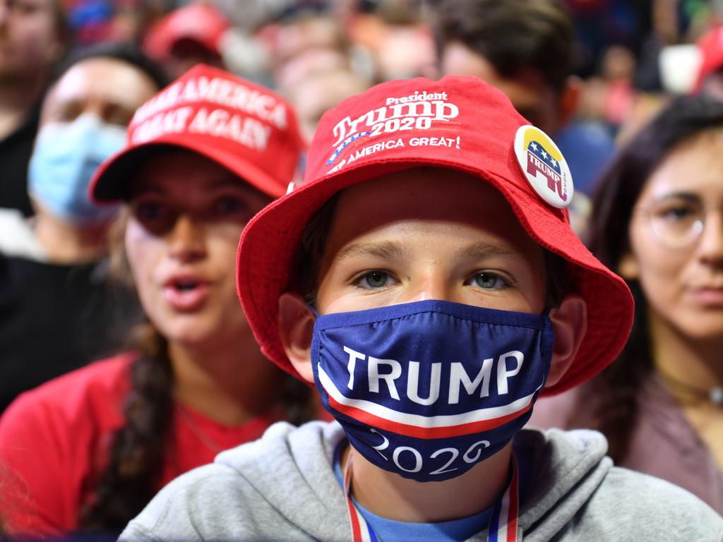 A young supporter wears a Trump 2020 mask as he listens to US President Donald Trump speak during a campaign rally on Saturday. Picture: Nicholas Kamm/AFP