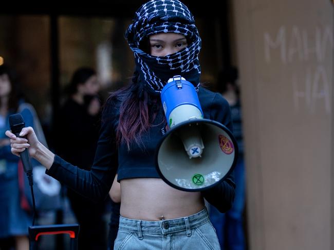 A protester speaks through a megaphone at Melbourne Uni. Picture: Jason Edwards