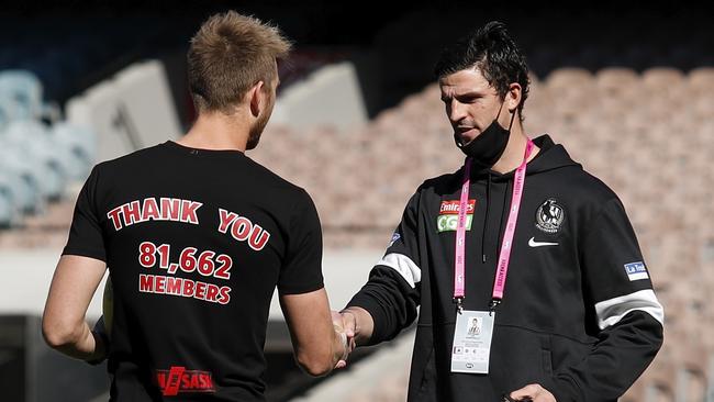 Heppell shakes hands with his Collingwood counterpart Scott Pendlebury. The Pies captain sat the final round out because of injury. Picture: AFL Photos via Getty Images