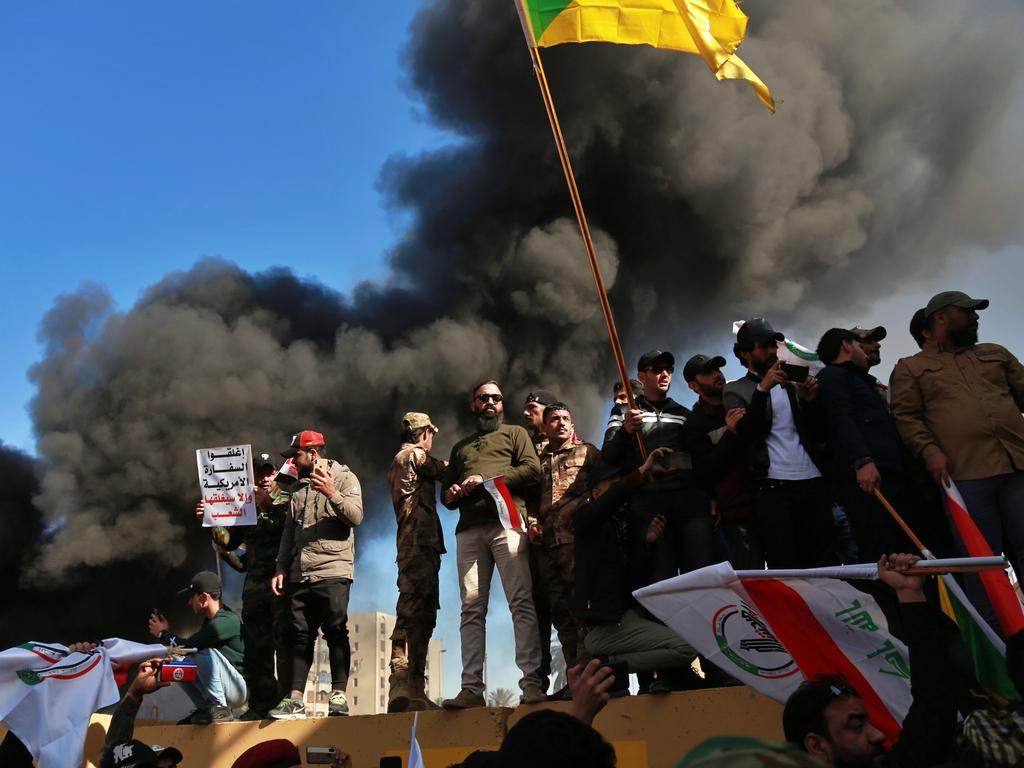 Protesters burn property in front of the US embassy compound, in Baghdad, Iraq. Picture: AP