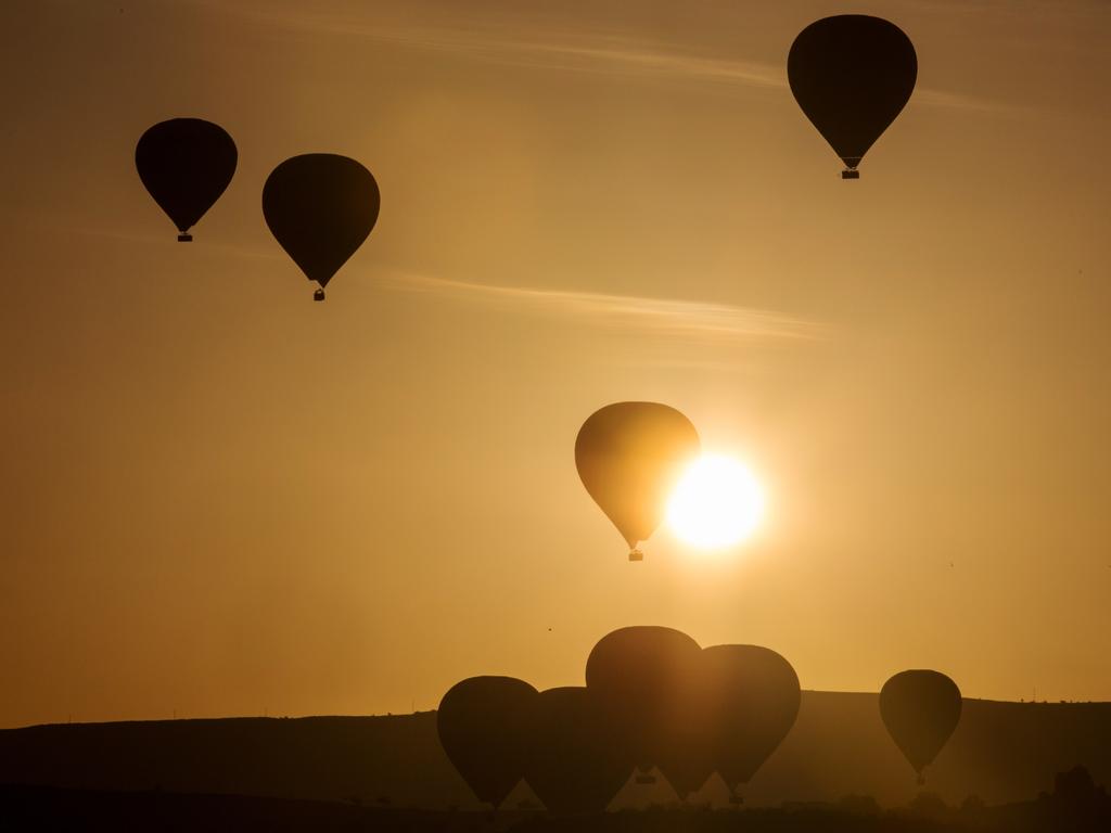 Tourists ride hot air balloons near the town of Goreme on April 19, 2016 in Nevsehir, Cappadocia. Picture: Getty