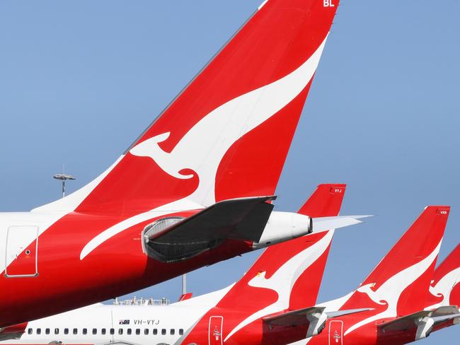 SYDNEY, AUSTRALIA - AUGUST 18: The tail fins of Qantas aircraft parked at Sydney's Kingsford Smith International Airport on August 18, 2021 in Sydney, Australia. Qantas Group has announced COVID-19 vaccinations will be mandatory for all 22,000 staff members. Frontline employees Ã¢â¬â including cabin crew, pilots and airport workers Ã¢â¬â will need to be fully vaccinated by November 15 and the remainder of employees by March 31. There will be exemptions for those who are unable to be vaccinated for documented medical reasons, which is expected to be very rare. (Photo by James D. Morgan/Getty Images)