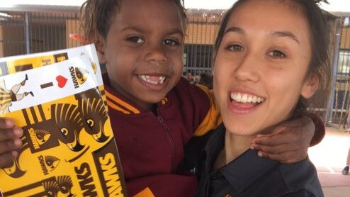 Rebecca Beeson and a brand new Hawks fan in the Northern Territory