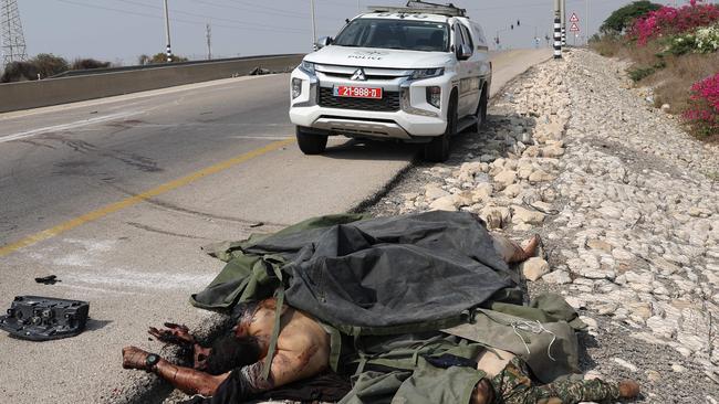 The covered bodies of Palestinian fighters are pictured on a road in Sderot. Picture: AFP