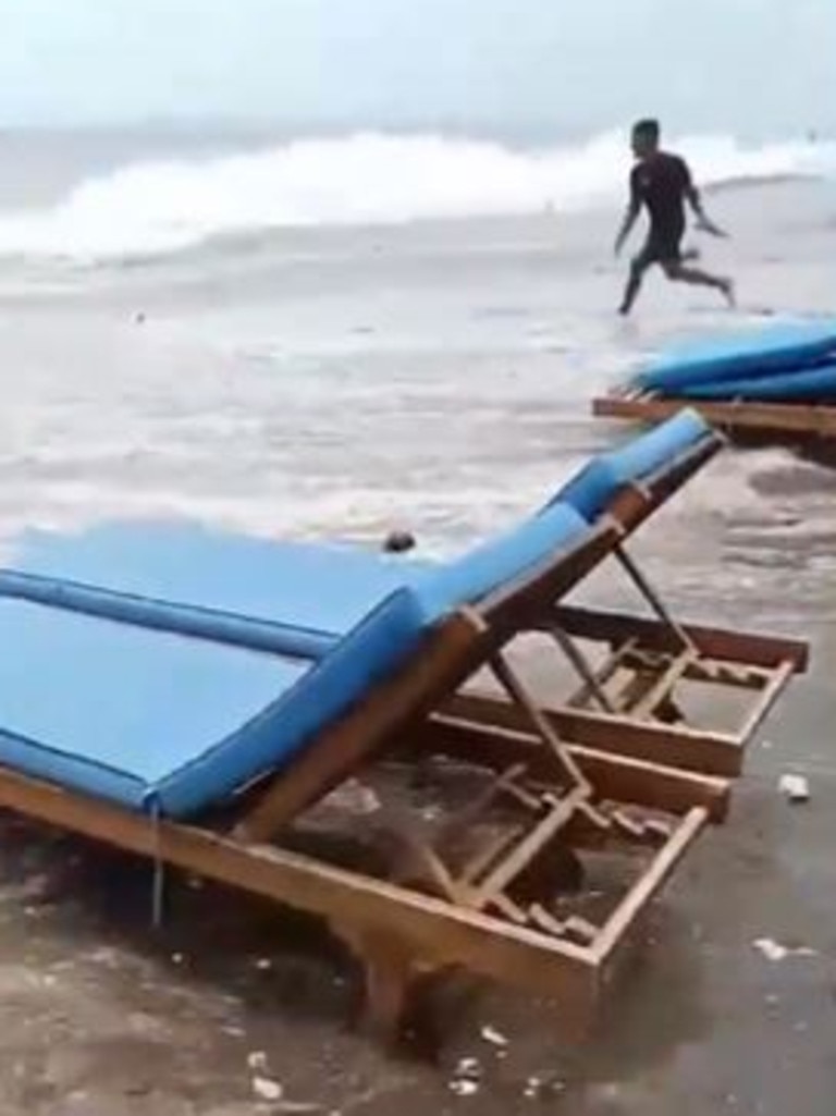 The video showed a man trying to save items caught in the waves.