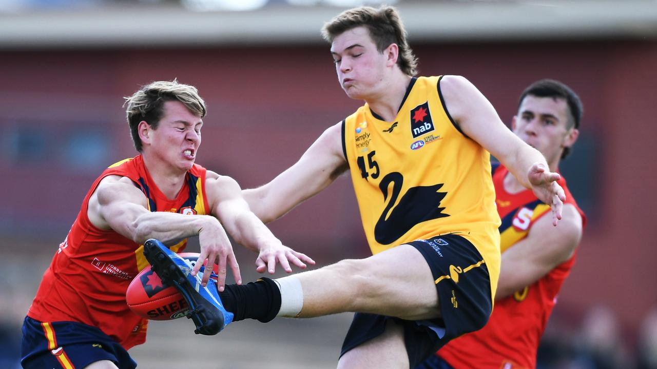 ADELAIDE, AUSTRALIA - OCTOBER 10: Joshua Cripps of Western Australia has his kick smothered by Blayne O'Loughlin of South Australia during the 2021 NAB AFL Draft U19 Challenge match between South Australia and Western Australia at Thebarton Oval on October 10, 2021 in Adelaide, Australia. (Photo by Mark Brake/AFL Photos/via Getty Images )
