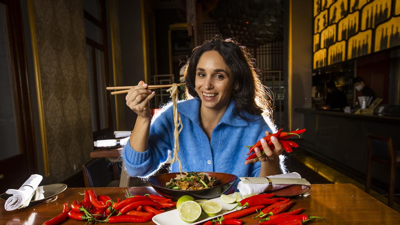 Diner Eleni Kozionas tries out the fiery char kway teow at Fat Noodle restaurant at Treasury Brisbane. Picture: Nigel Hallett