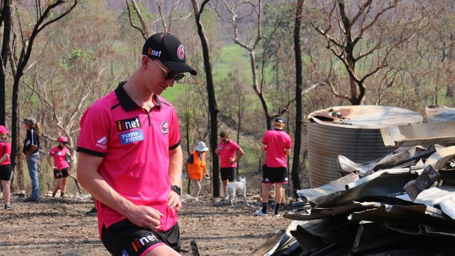 Sydney Sixers player Jordan Silk takes a moment to reflect on the tragic situation at fire ravaged Nymboida during a team visit ahead of their BBL09 fixture with Adelaide Strikers at C.Ex International Stadium in Coffs Harbour on Sunday, 5th January, 2019.