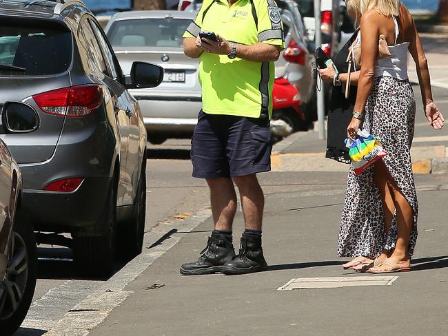 A council ranger explains the parking rules to members of the public in Manly. File picture: Manly Daily