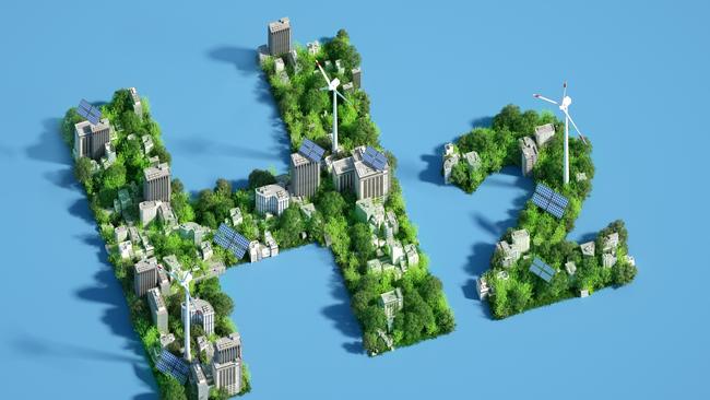 EMBARGO FOR TWAM 18 DEC 2021. FEES MAY APPLY. Digital generated image of H2 hydrogen icon made out of green sustainable city with wind turbines and solar panels  on blue background.