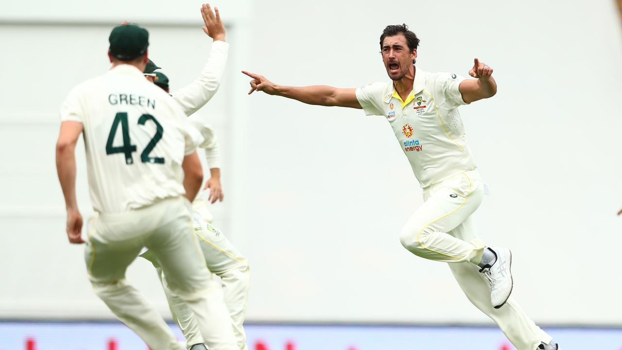 Mitchell Starc celebrates after knocking over Rory Burns first ball. Picture: Chris Hyde/Getty Images