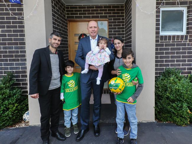 Assyrian Christians from Iraq Faris Sora and Diana Shaheen met Peter Dutton when he issued them their visa at the Australian Embassy in Jordan in November 2015. Picture: Ian Currie