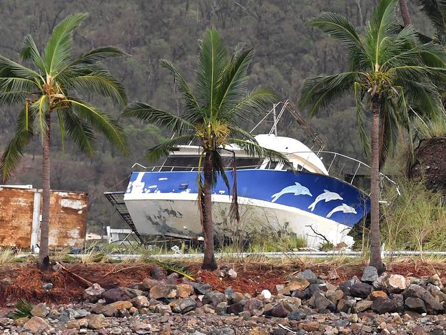A boat is seen smashed against the bank at Shute Harbour, Airlie Beach, Wednesday, March 29, 2017. Cyclone Debbie has hit Queensland’s far north coast yesterday as a category 4 cyclone, causing wide spread damage. Picture: AAP Image/Dan Peled