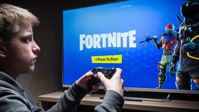 Teenager playing Fortnite on a Playstation 4