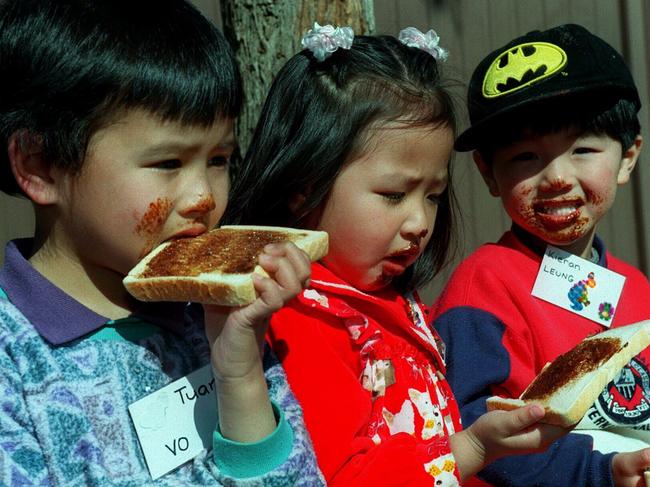 Asian migrant children eating vegemite sandwiches.Food / Sandwich / SpreadMigrants To Australia