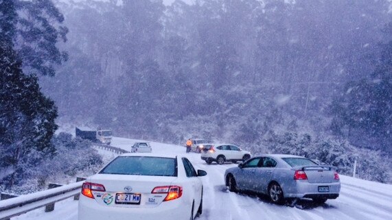 Hobart Snow. Image by Selina Smith. Cars at Black Charlies strewn over the rock in icy conditions.