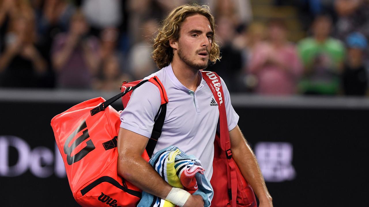 Stefanos Tsitsipas leaves the court after losing his third round match against Milos Raonic.