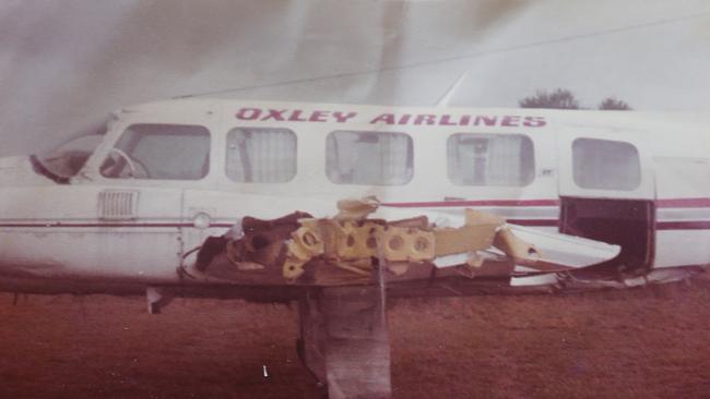 85 year old Ted Woodbry from Southport has cheated death numerous times, and reckons he must have a guardian angel looking after him. Copy pics of the Oxley airlines plane he crashed in at Port Macquarie in 1985, and Ted being taken away on a stretcher. Picture Glenn Hampson