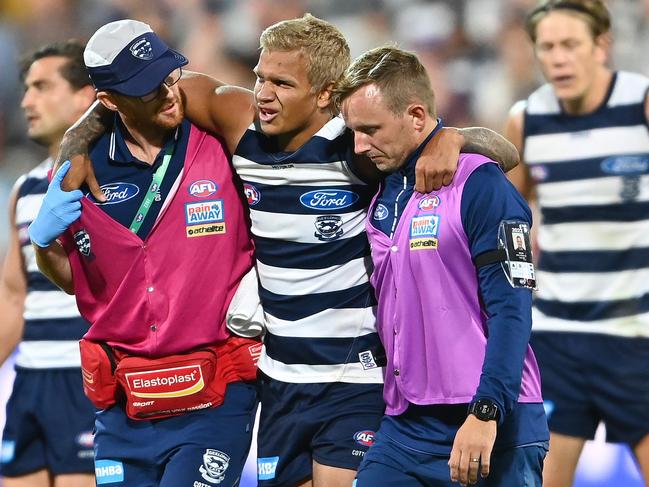 Quinton Narkle is helped from the ground after his ankle injury. Picture: Quinn Rooney/Getty Images