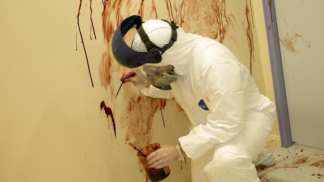 Shawn Harkins uses a pipette filled with horse blood to create the realistic crime scenes. Photo: Richard Tuffin