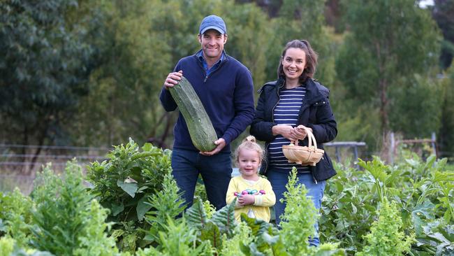 Jasmin and Hayden with daughter Pippa on Ravens Creek Farm. Picture: Andy Rogers