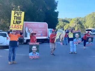 Volunteers for Craig Crawford displaying signs urging voters to put the LNP last.