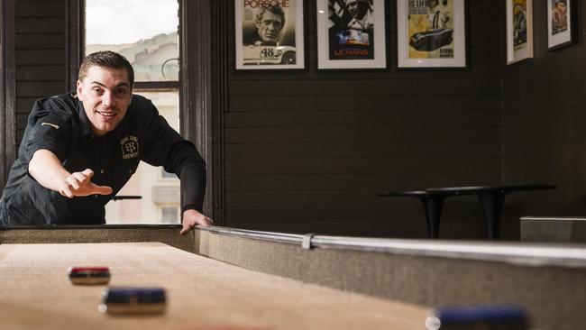 Bone Idol Bar venue manager Calum Gunnis with the venues shuffleboard tables, Friday, November 10, 2023. Picture: Kevin Farmer