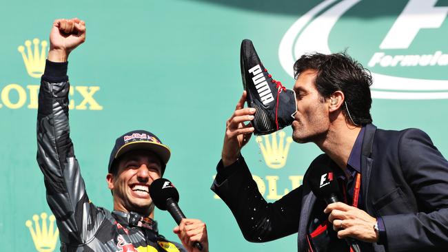 Mark Webber drinks champagne from the boot of Daniel Ricciardo at the Belgium Grand Prix in 2016. Ricciardo will overtake Webber as Australia’s most experienced F1 driver this weekend. Photo: Getty Images