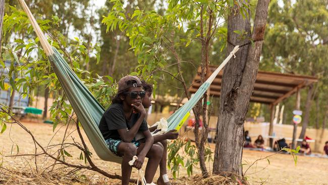 Yolngu boys sit in a hammock during the Garma Festival. Picture: Tamati Smith/ Getty Images