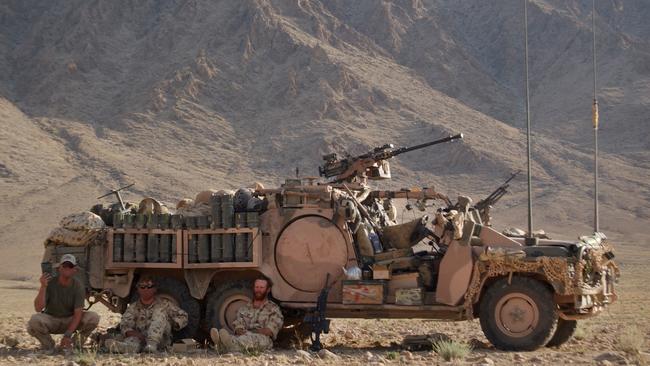 Trooper Mark Donaldson and members of the SASR get some respite in the shade of a Long Range Patrol Vehicle near Chora, Afghanistan in 2006. Picture: Department of Defence