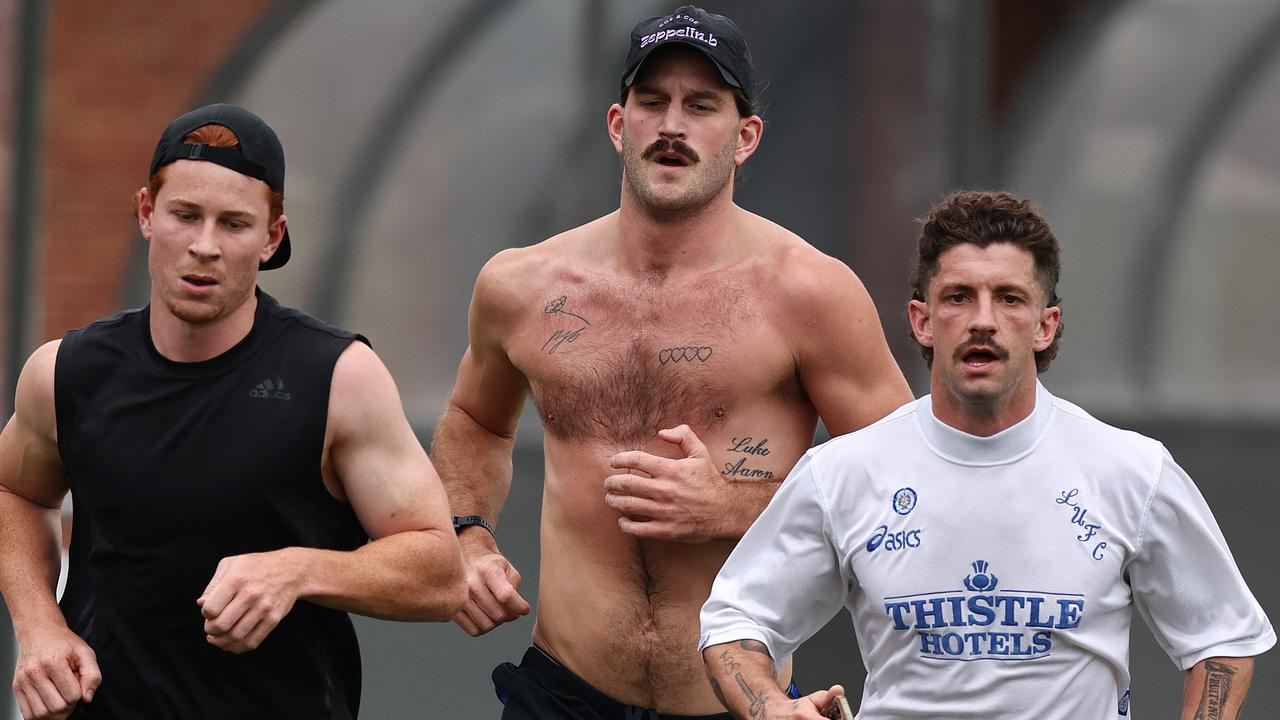 Ed Richards, Josh Bruce and Tom Liberatore run laps as they prepare for the coming season. Picture: Michael Klein