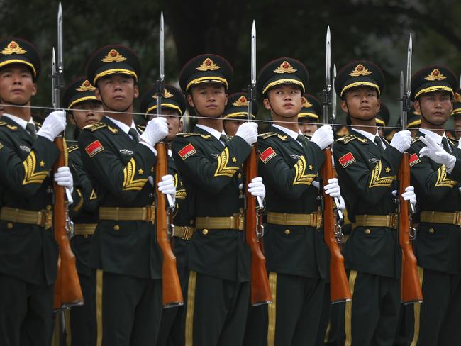 Members of an honor guard prepare for a welcome ceremony for visiting Abu Dhabi's Crown Prince Sheikh Mohammed bin Zayed Al Nahyan at the Great Hall of the People in Beijing, Monday, July 22, 2019. (AP Photo/Andy Wong)