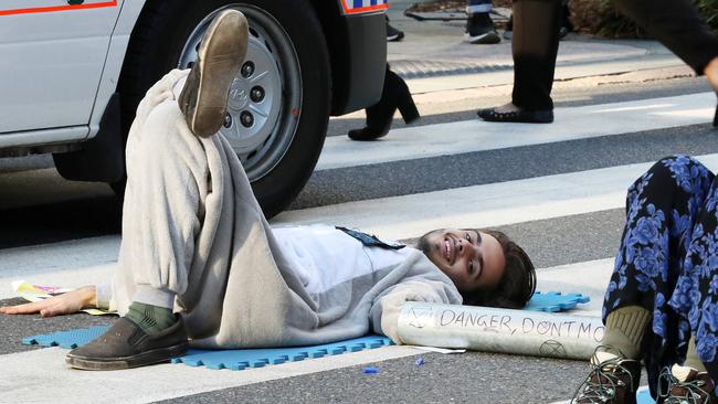 A protest by Extinction Revolution which brought Brisbane’s CBD to a standstill saw two protesters glue themselves to the road in Post Office Square. Picture: Liam Kidston.