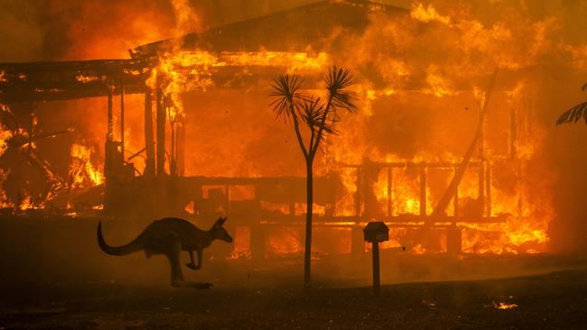 Flames engulf a home in the NSW south coast town of Lake Conjola. Picture: Matthew Abbott