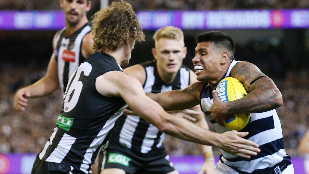 Tim Kelly shrugs off Chris Mayne during a Geelong-Collingwood match this year. Picture: Michael Klein.