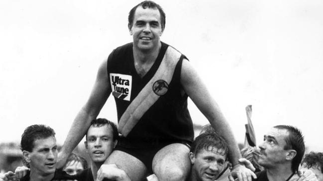 Glenelg champion Peter Carey is carried from the field in triumph by John Seebohm and Chris McDermott after breaking the Australian senior games record in 1988. Picture: File Photo