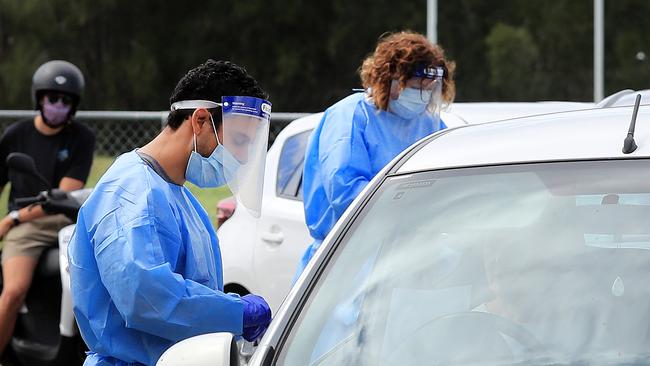 QML Pathology staff test Gold Coast locals who have to wait hours to be tested for Covid-19 at the Currumbin Eagles Rugby League Club which has turned into a Pop Up Testing. Picture: NCA NewsWire / Scott Powick